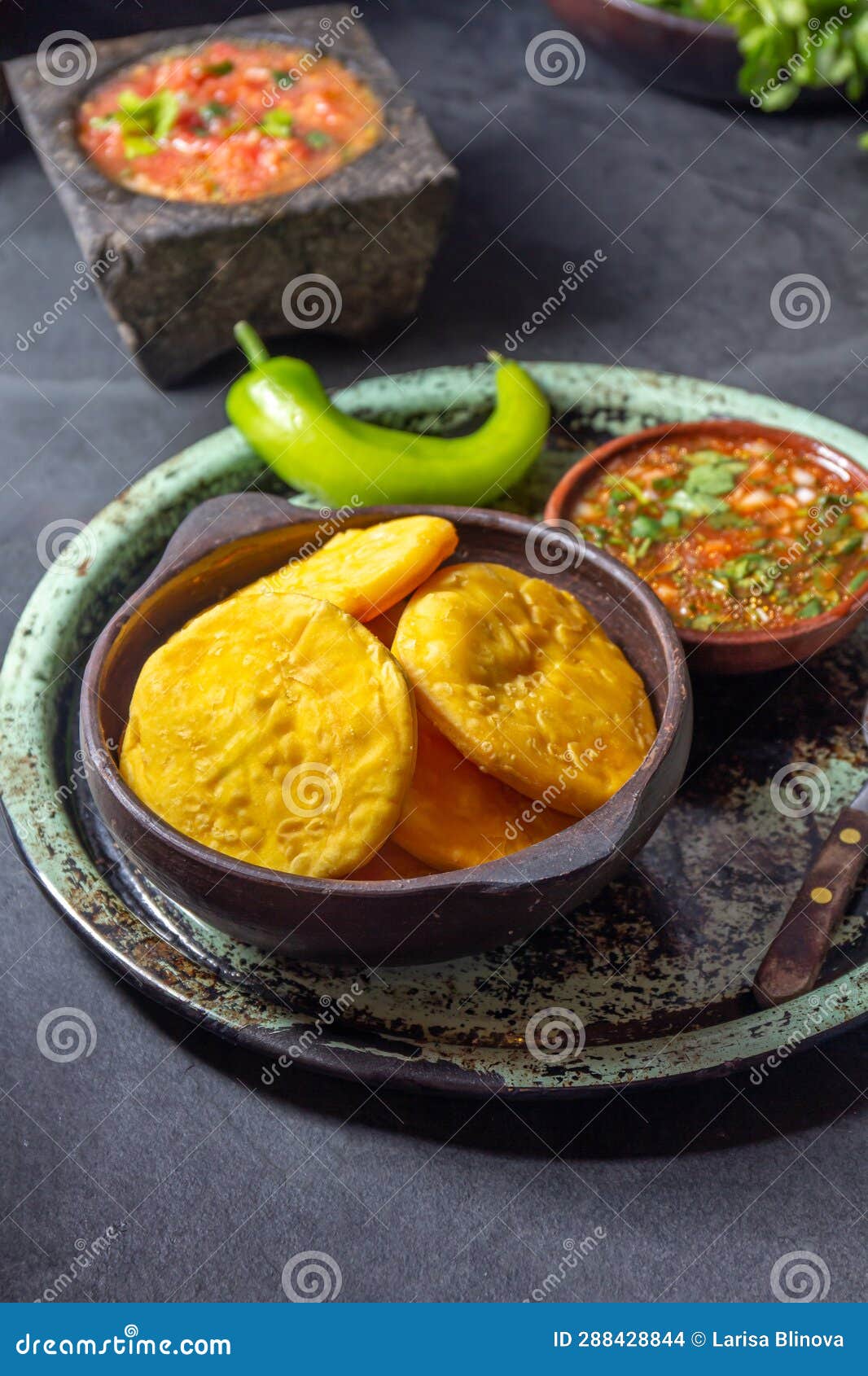 sopaipilla. latin american food. traditional chilean homemade pumpkin sopaipillas with typical salsas - chancho en