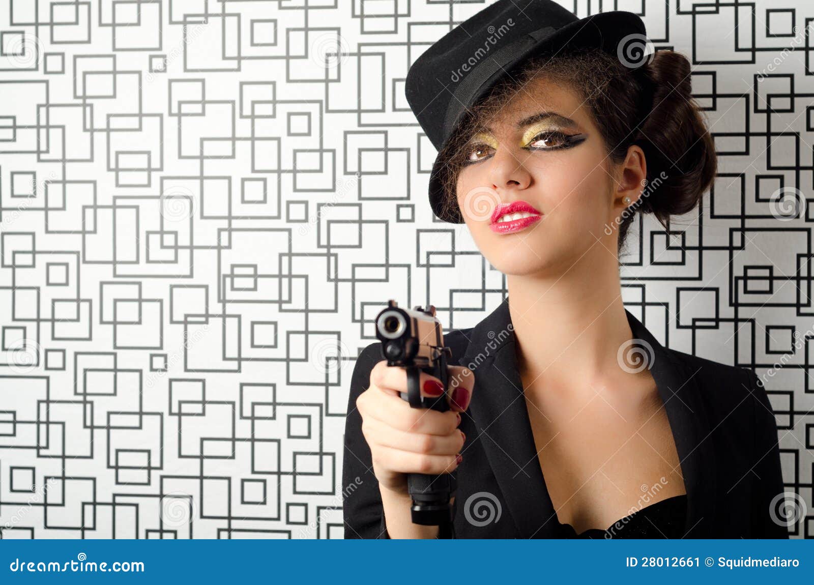 Sophisticated woman holding a gun in her hands