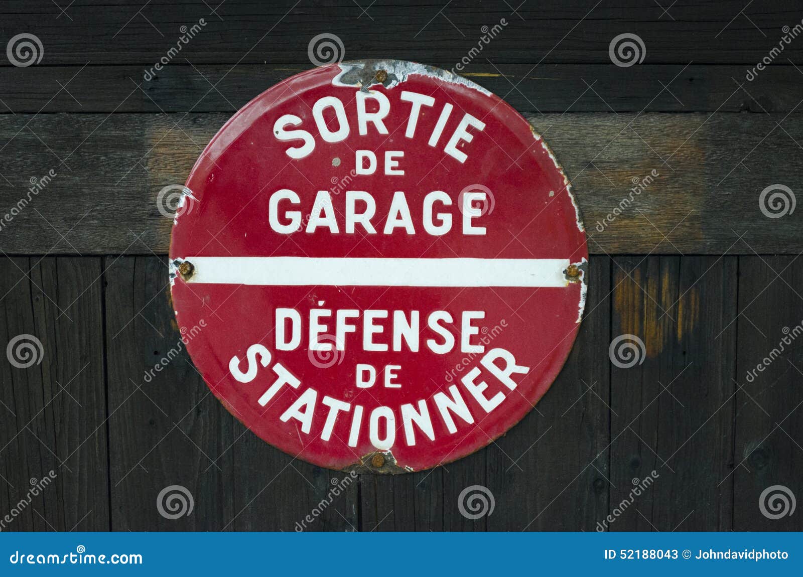 French 'Defense De Stationner - Sortie De Voitures' (No Parking - Car Exit)  sign on garage doors Stock Photo - Alamy