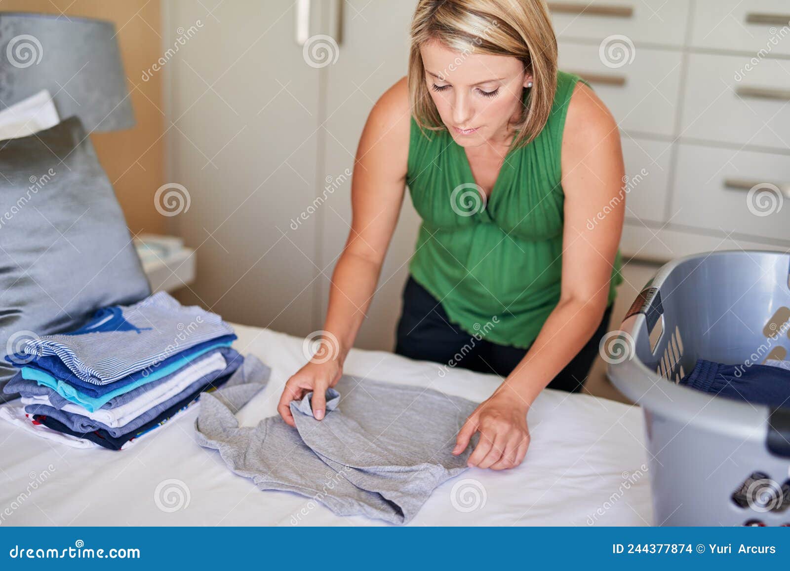 Sorting Out Some Laundry. Shot of a Young Woman Folding Up Some Laundry