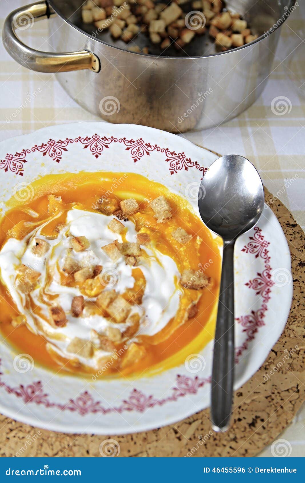 Image of a plate of pumpkin soup on a table