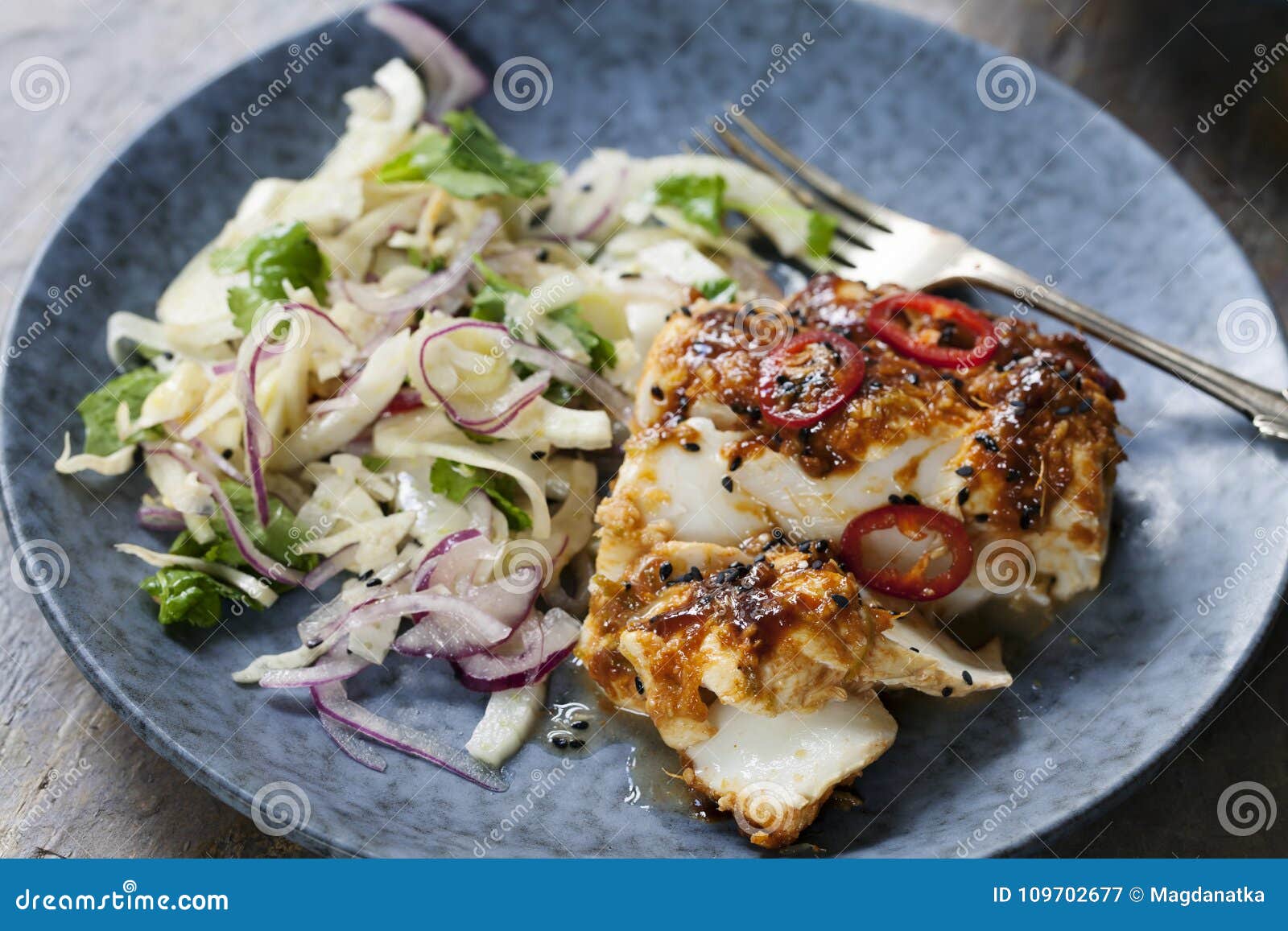 Soy and Ginger Glazed Cod with Fennel and Onion Salad Stock Image