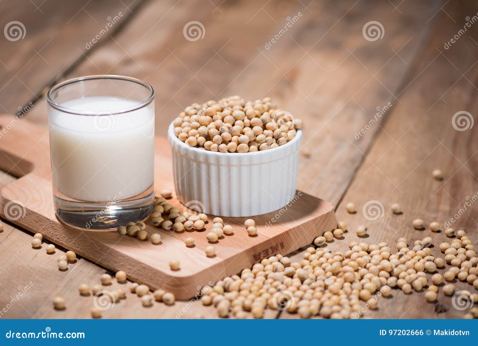 soy milk or soya milk and soy beans in spoon on wooden table.