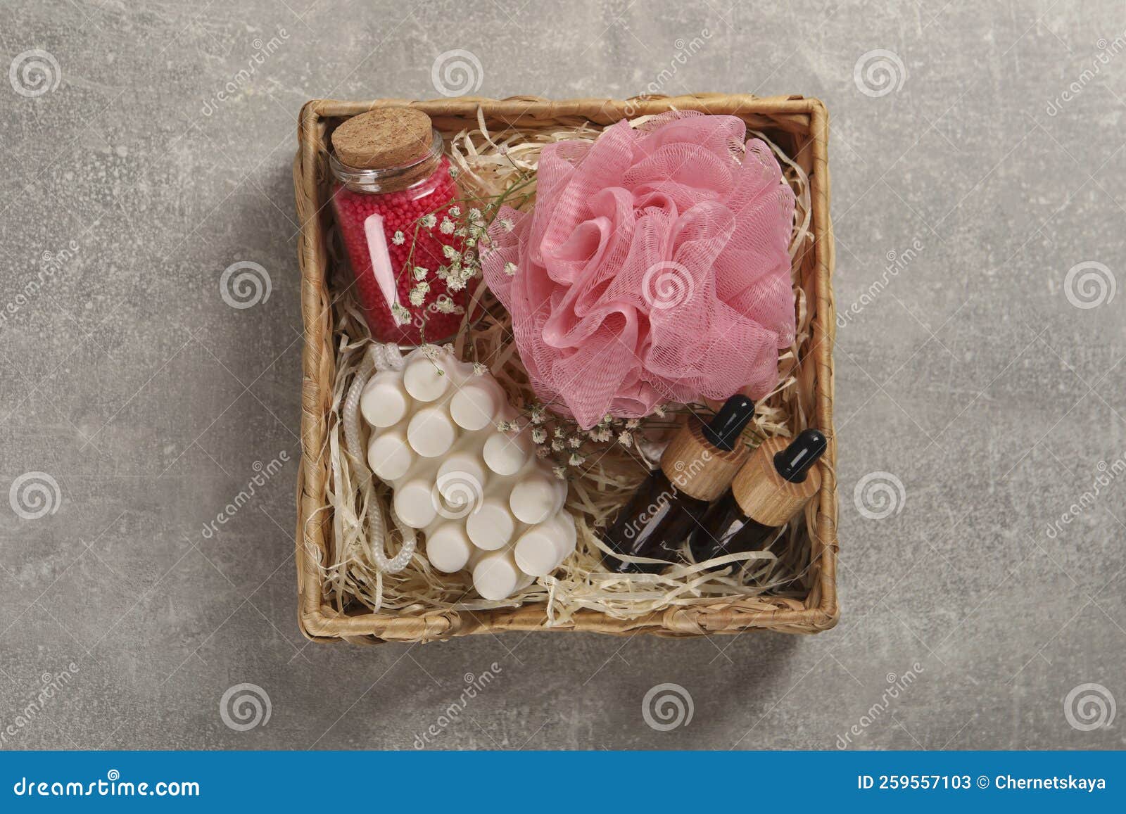 Spa Gift Set of Different Luxury Products in Wicker Basket on Grey