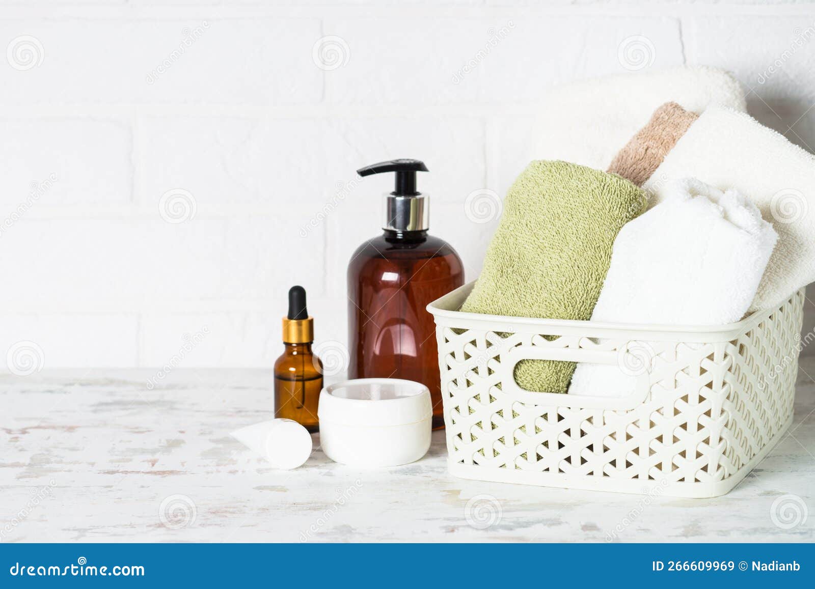 Bottle of Soap and Stack of Towels in White Bathroom. Stock Image