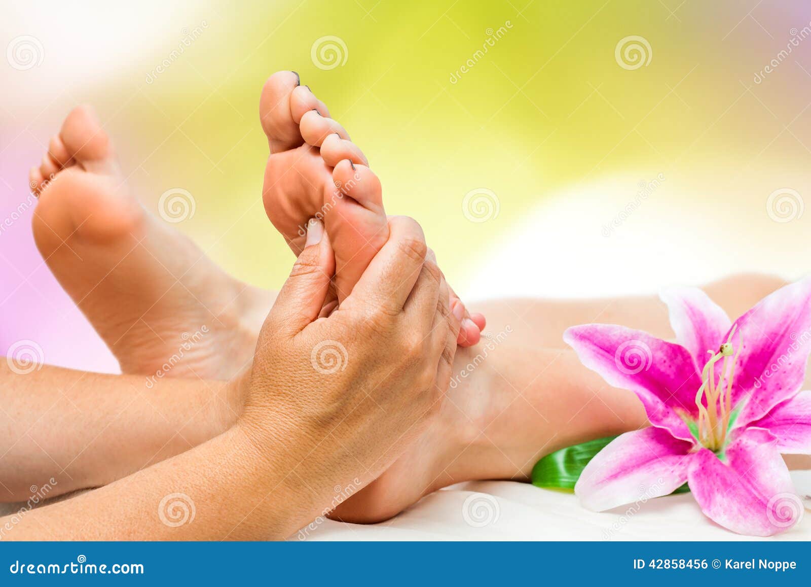 spa therapist doing foot massage