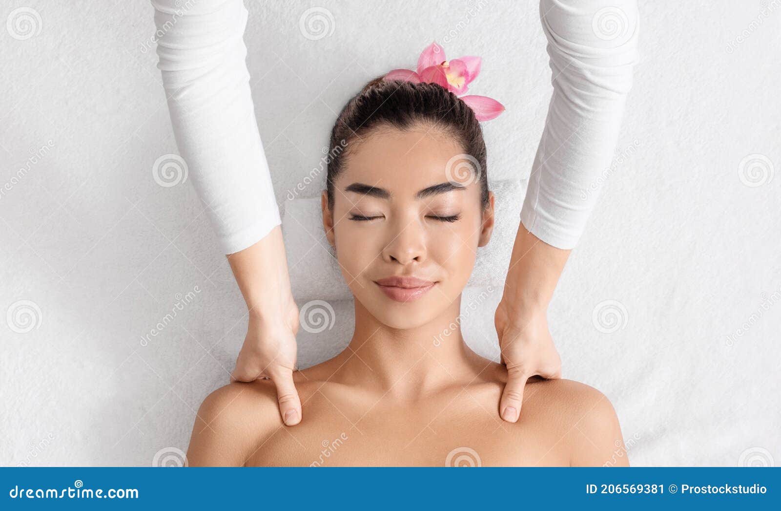 Close-up Hands Of Male Masseur Doing Back Massage To Young 