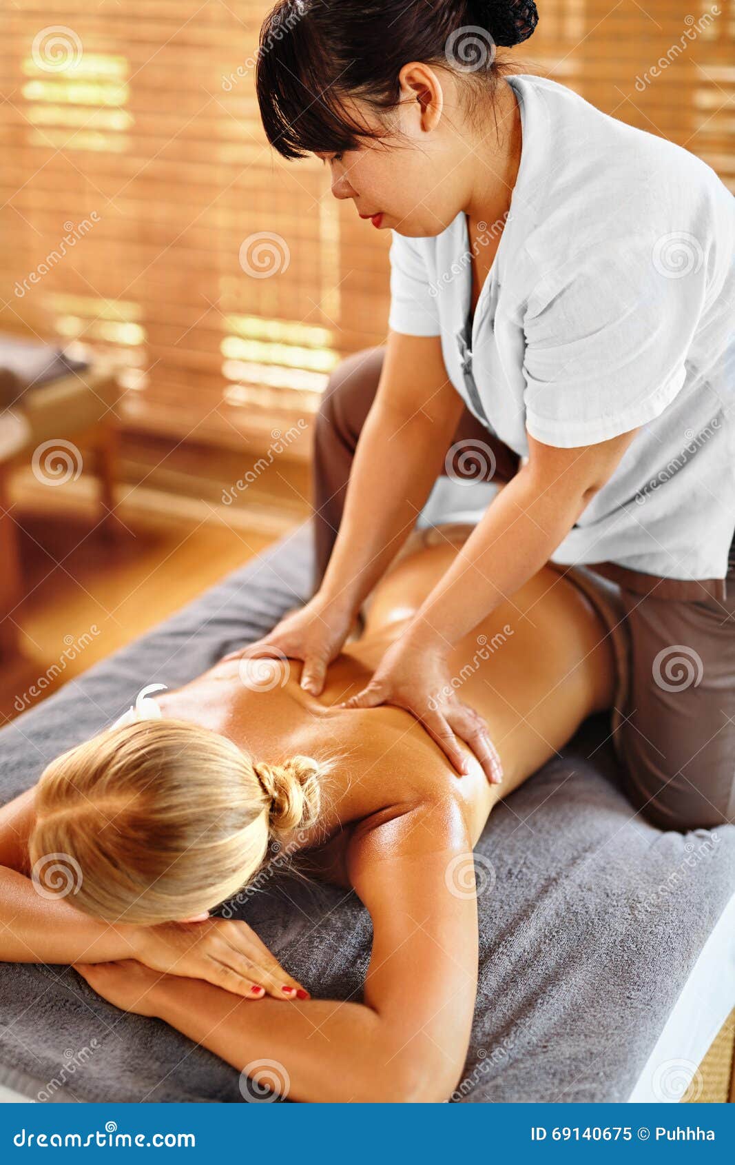 Body care. Relaxed woman enjoying back massage Stock Photo by