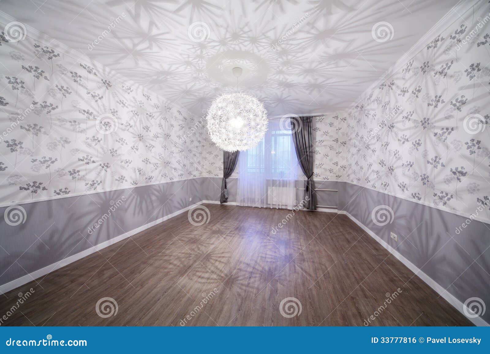 Spacious Light Room With Wooden Floor And Unusual Chandelier Stock