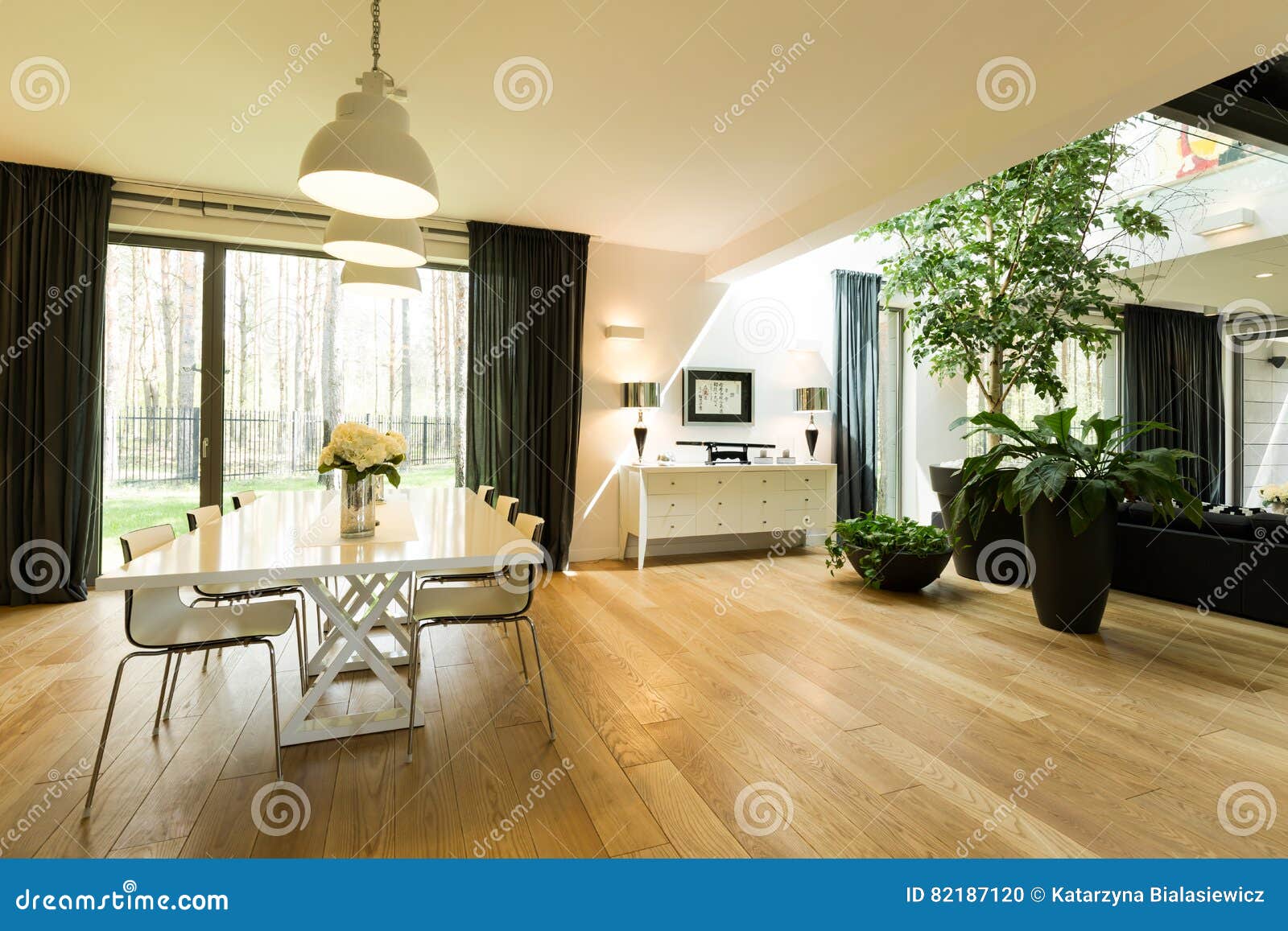 spacious room with table and plants