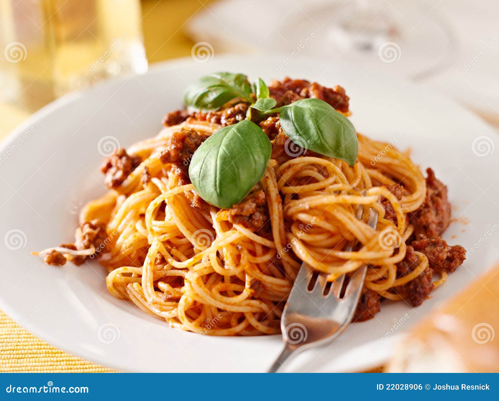 Spaghetti with Basil Garnish in Meat Sauce Closeup Stock Photo Image