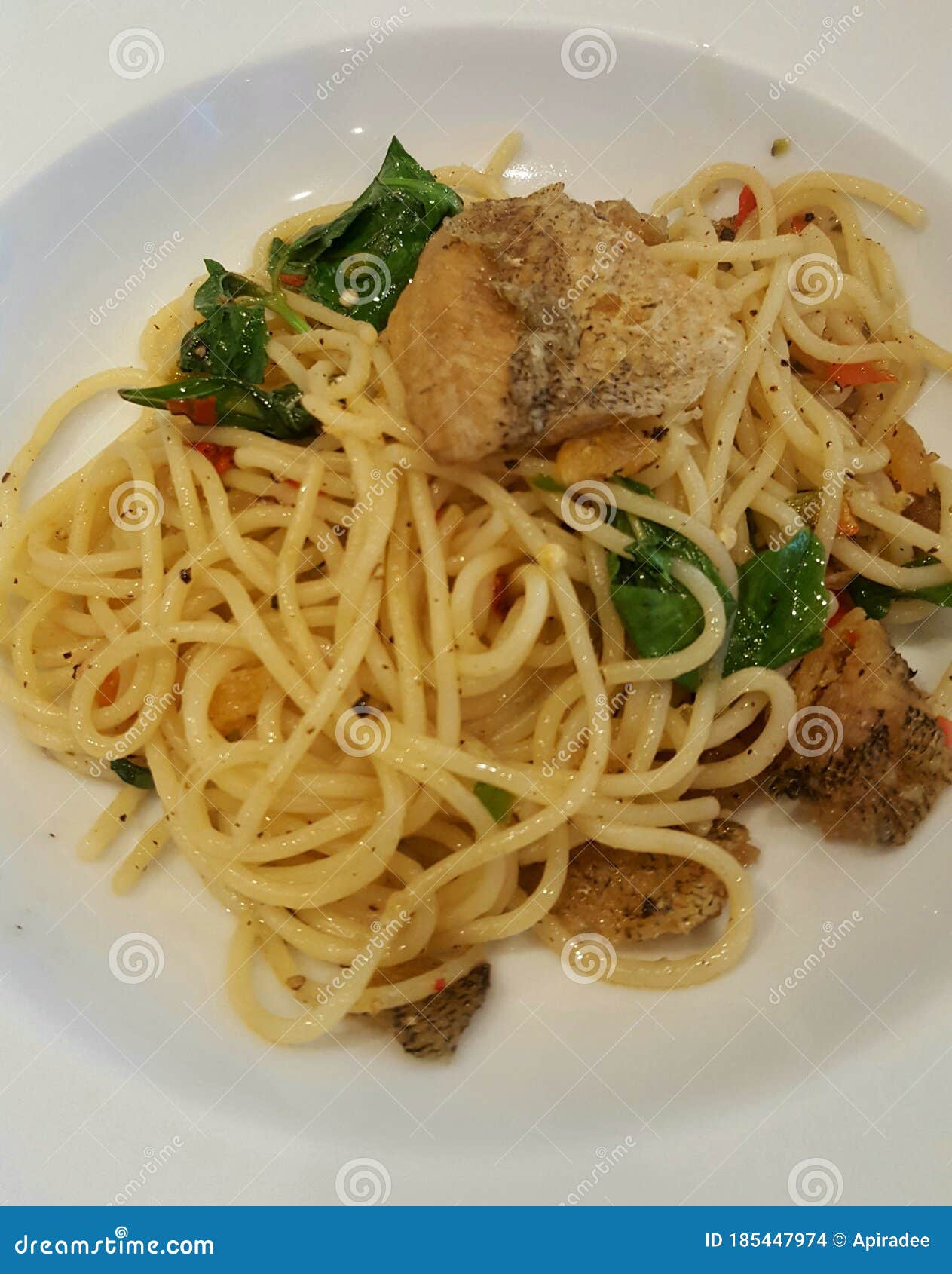 Spaghetti with fried fish stock photo. Image of noodle 185447974