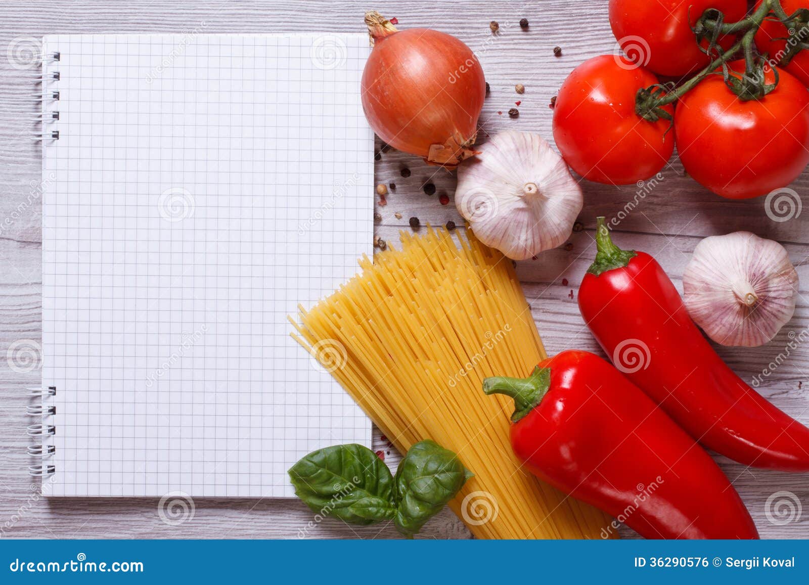 Spaghetti and Ingredients for Preparing Pasta on the Table Stock Photo