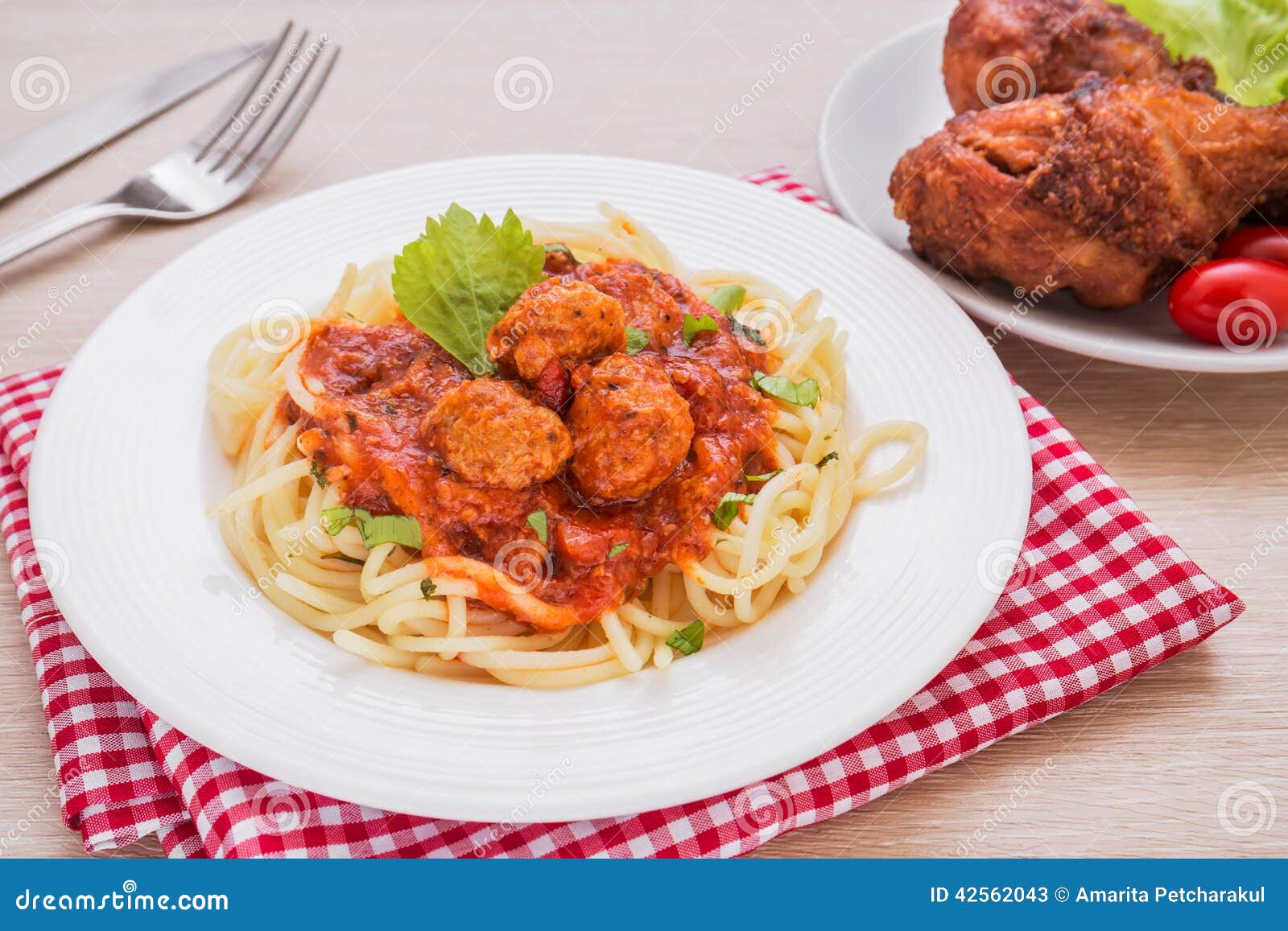 Spaghetti with Meatballs in Tomato Sauce and Fried Chicken Stock Image