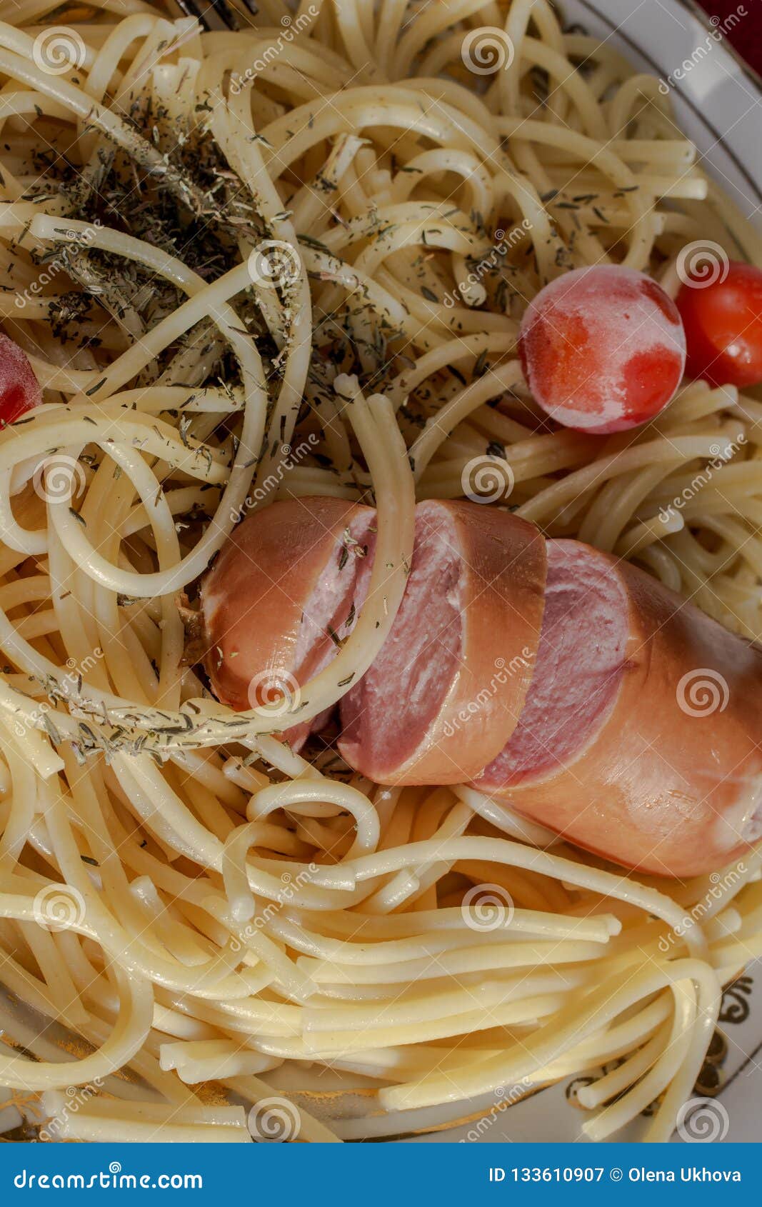 Spaghetti with Spices and Frozen Tomatoes on a Plate. Part of Th Stock