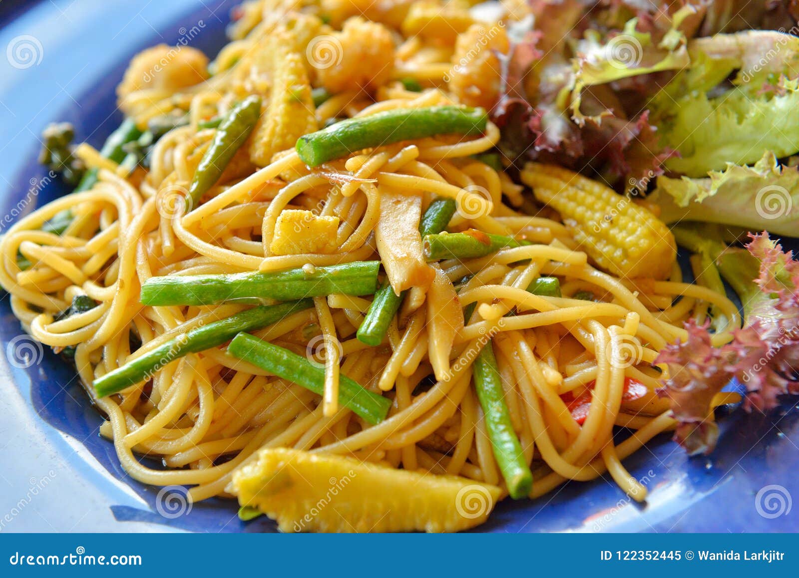Spaghetti with Young Corn and Green Bean on Blue Plate Stock Image