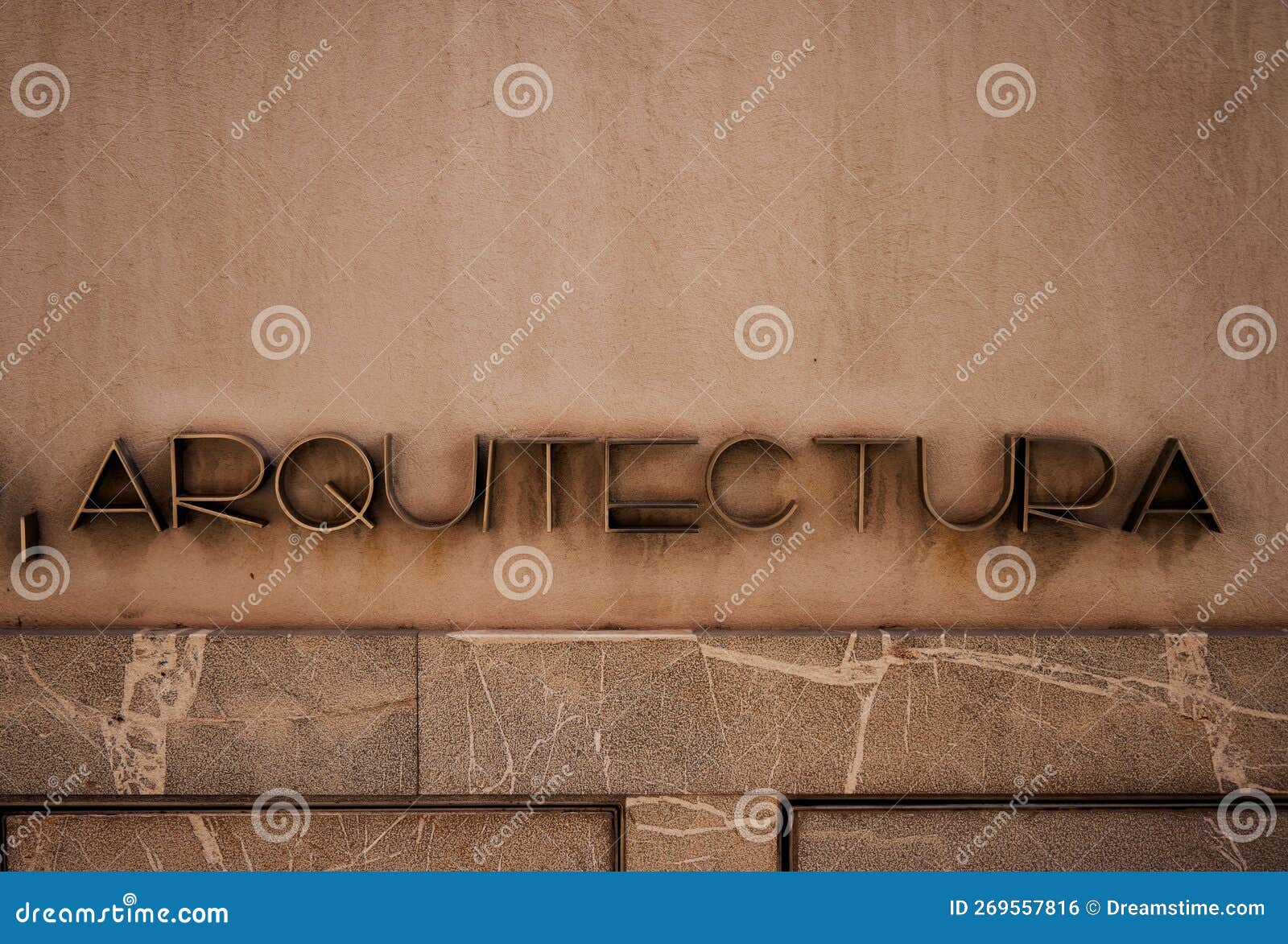 spanish arquitectura word meaning architecture on a stone facade wall