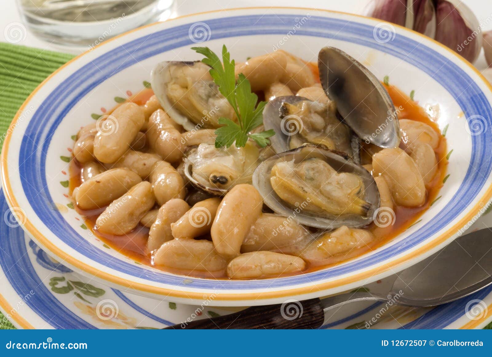 spanish cuisine. asturian clams and beans.
