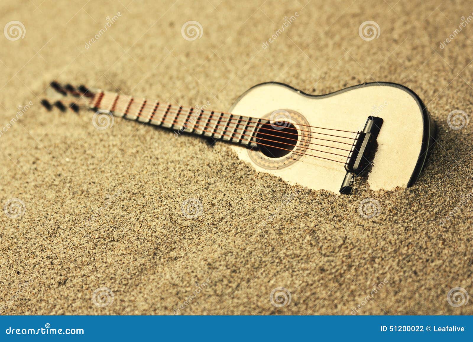 Spanish guitar in the sand stock photo. Image of object 51200022