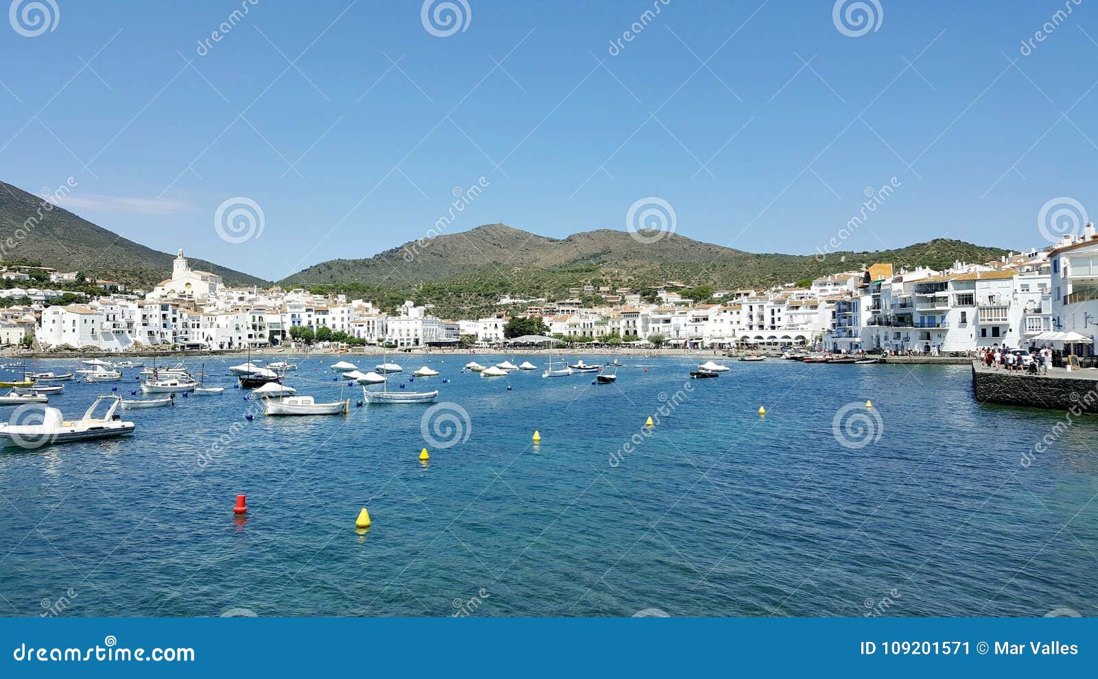 spanish port full of boats and white houses