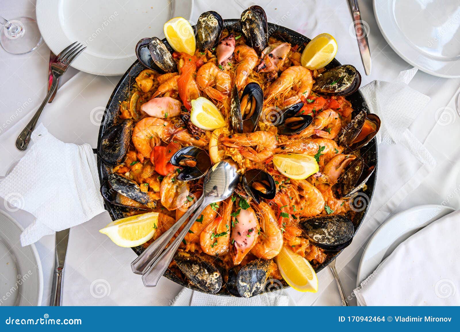 Spanish Seafood Paella Rice Dish with Fresh Shrimp, Scampi, Mussels