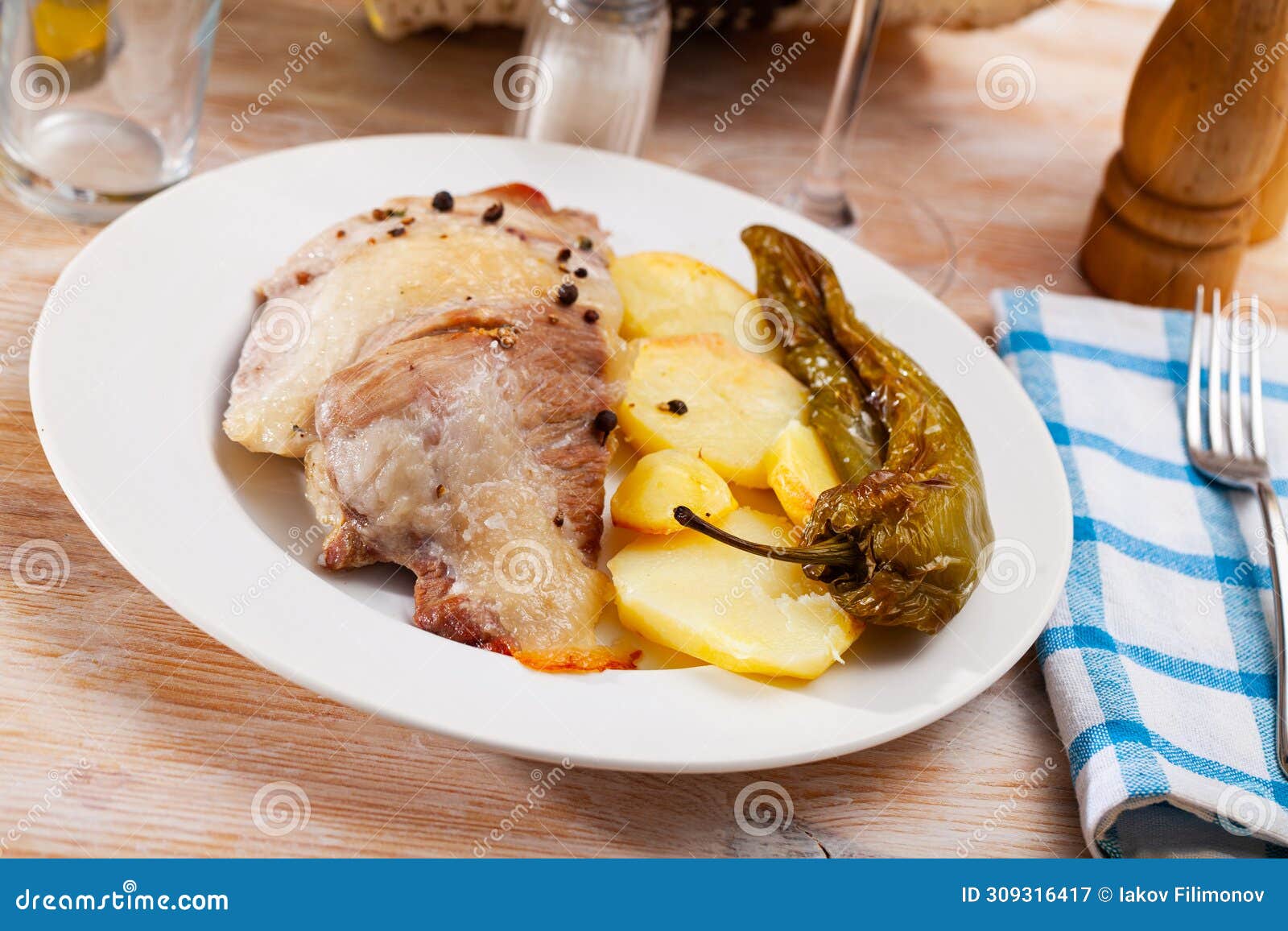spanish secreto de cerdo - roasted pork served with potatoes, stewed pepper