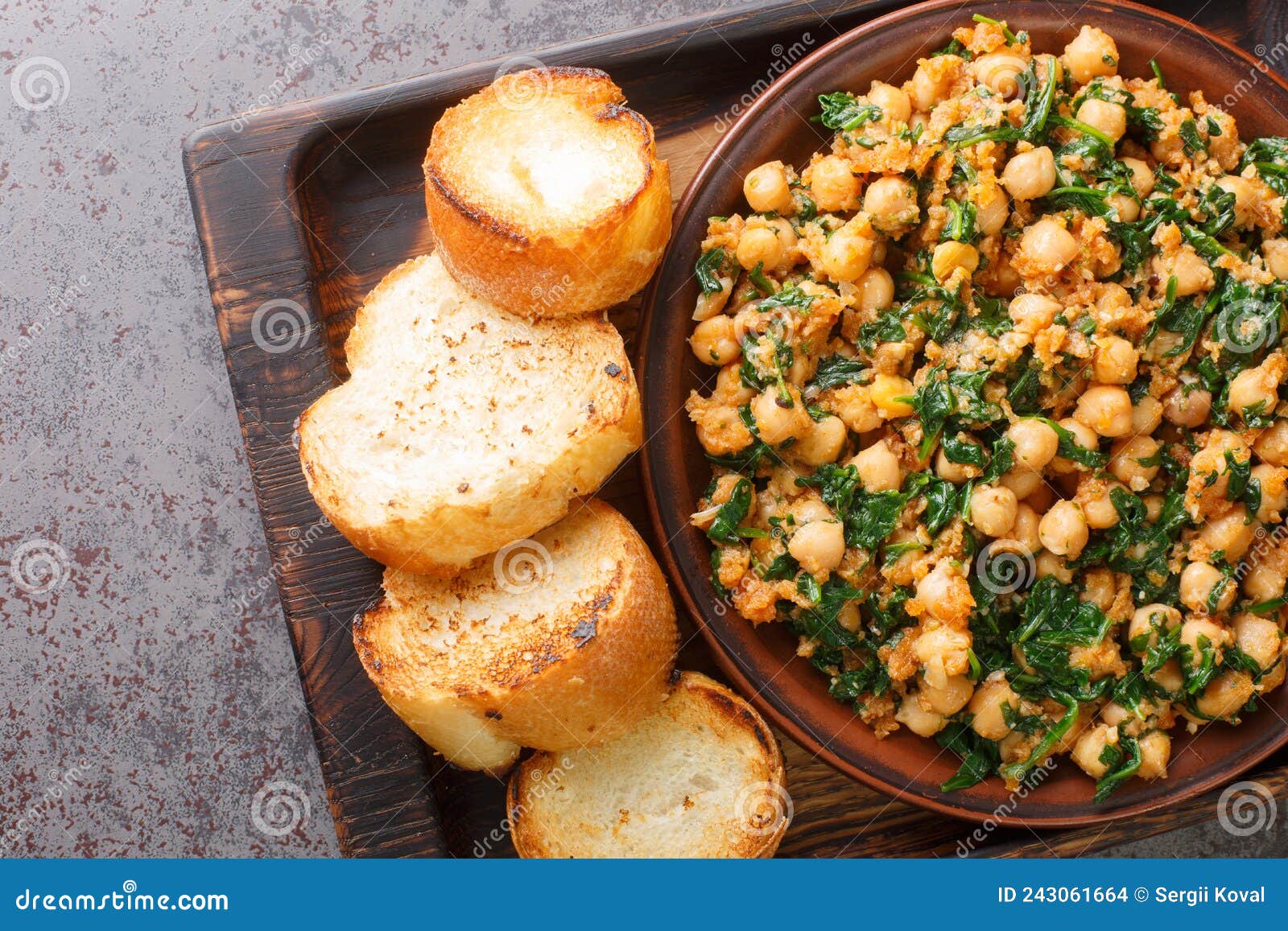 Spanish Spinach and Chickpeas Served with Toasts Closeup in the Plate
