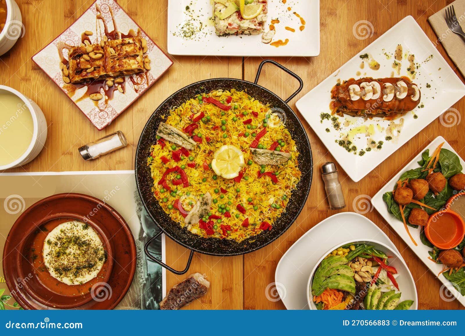 Spanish Tapas Recipes with a Fish Paella in the Center, Healthy Salads