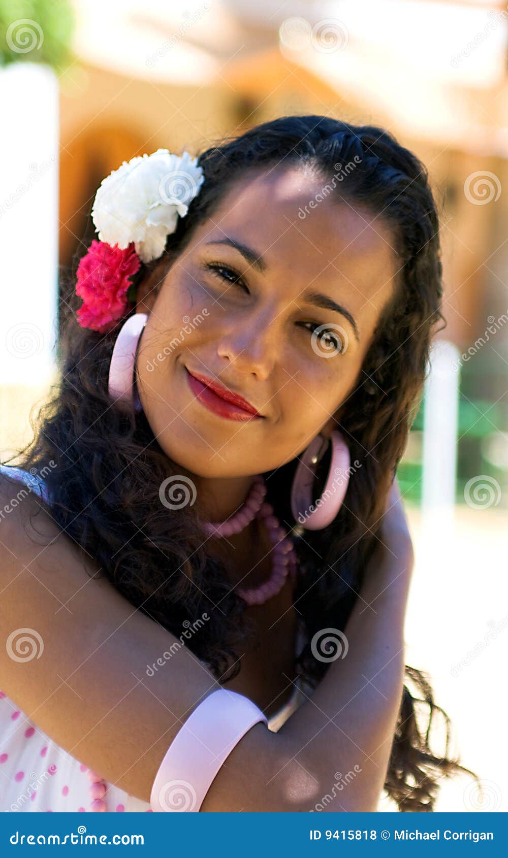spanish woman in feria dress adjusts hair