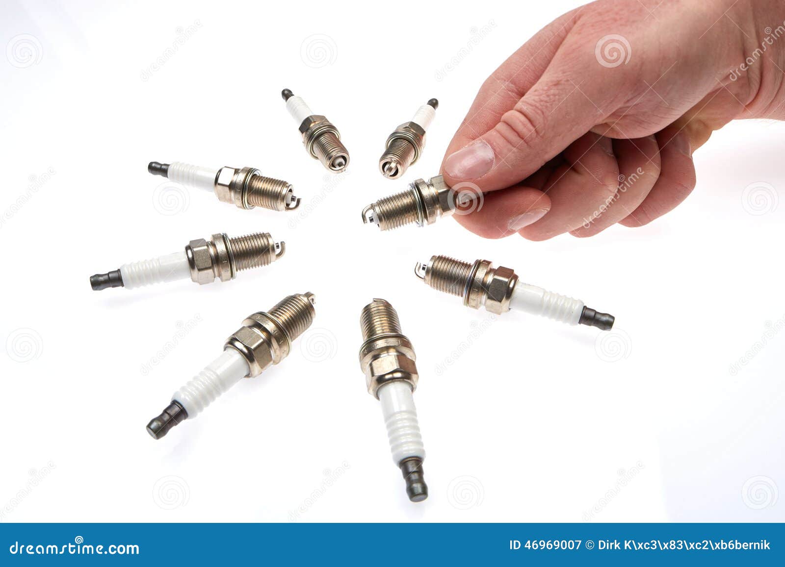 8 spark plugs and a hand stock image. Image of spark 46969007