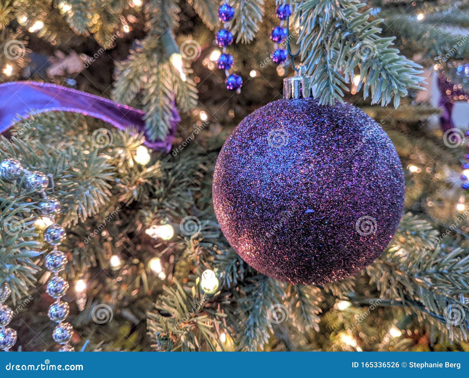 Sparkly Purple Christmas Ornament on a Tree Stock Photo - Image of ...