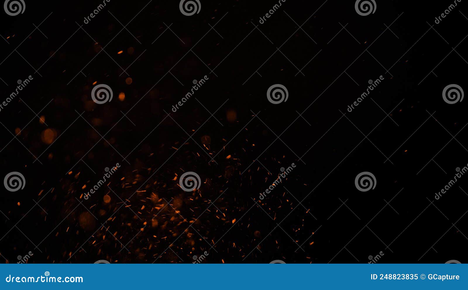 sparks like particles floating in air over black background