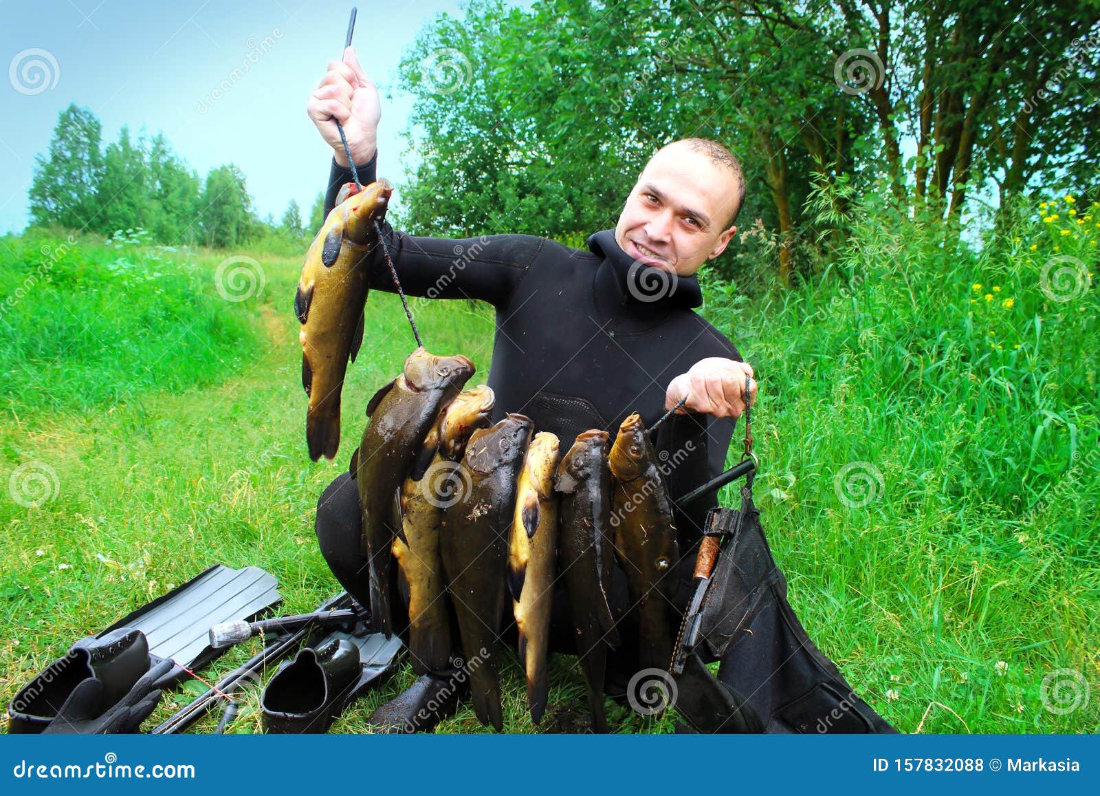 Spearfishing. a Man in a Wetsuit with a Fish Caught Stock Photo