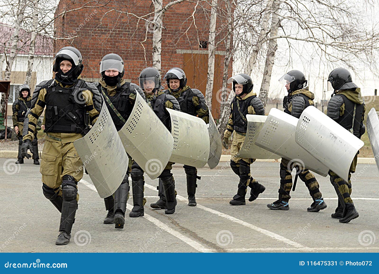 Group of police forces in uniform using riot shields for protection while  stopping activists outdoors Stock Photo - Alamy