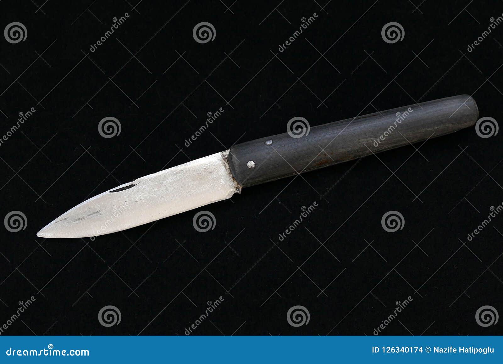 A Special Turkish Knife. Testing the Sharpness of the Blade on the Black Floor. a Small Pocket