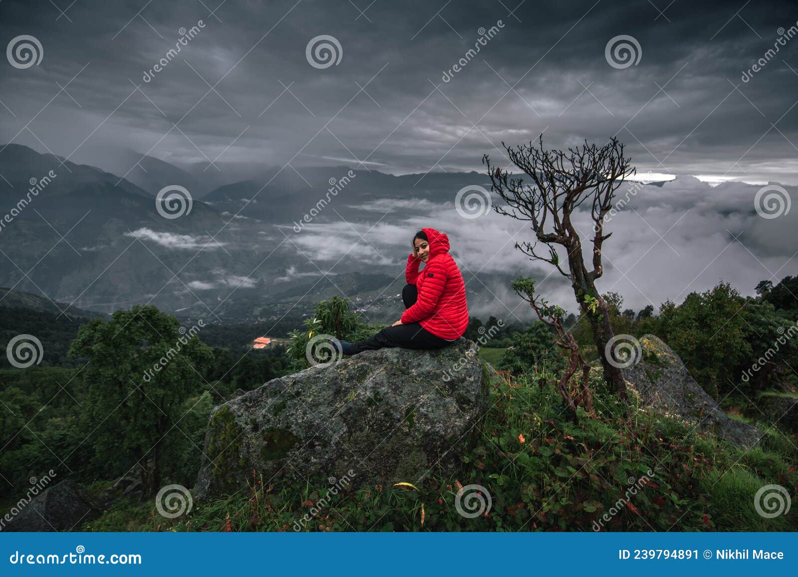 young woman sit alone, has mountain, sky are background. image for travel, scenery, lonely, portrait, person, landscape ,