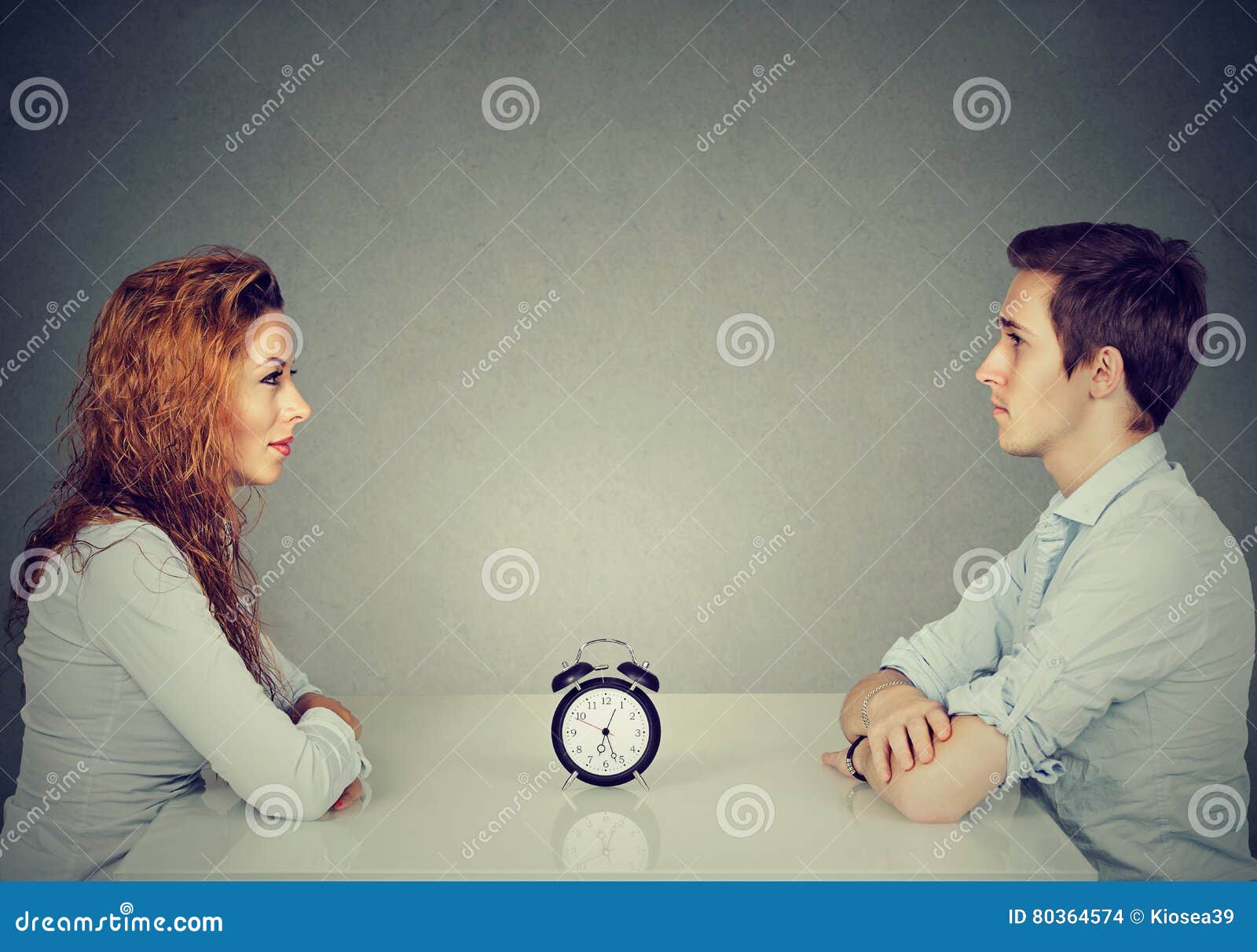 speed dating. man woman sitting across from each other at table