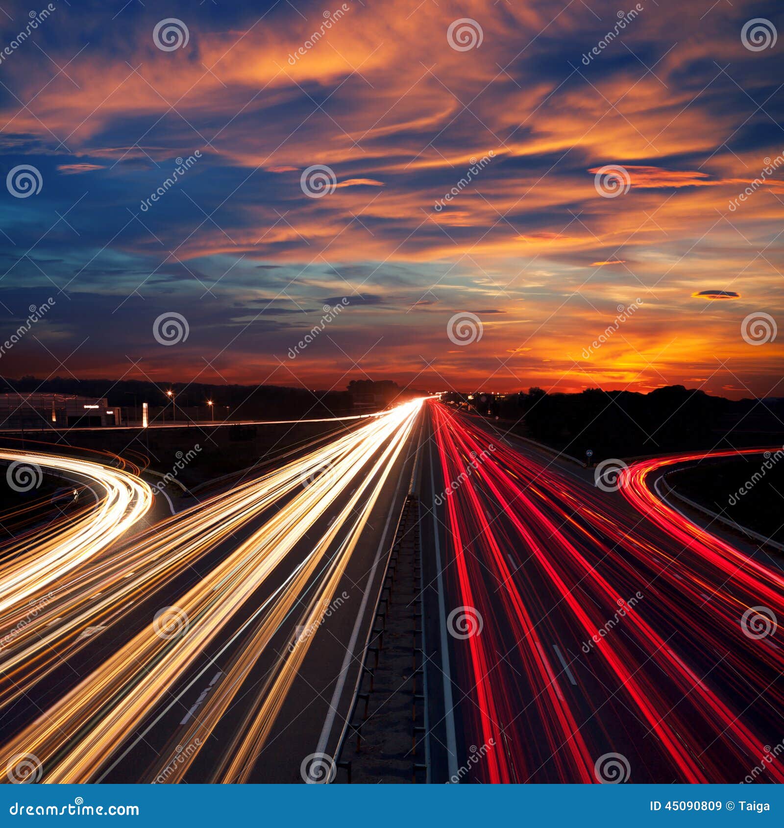 speed traffic at dramatic sundown time - light trails