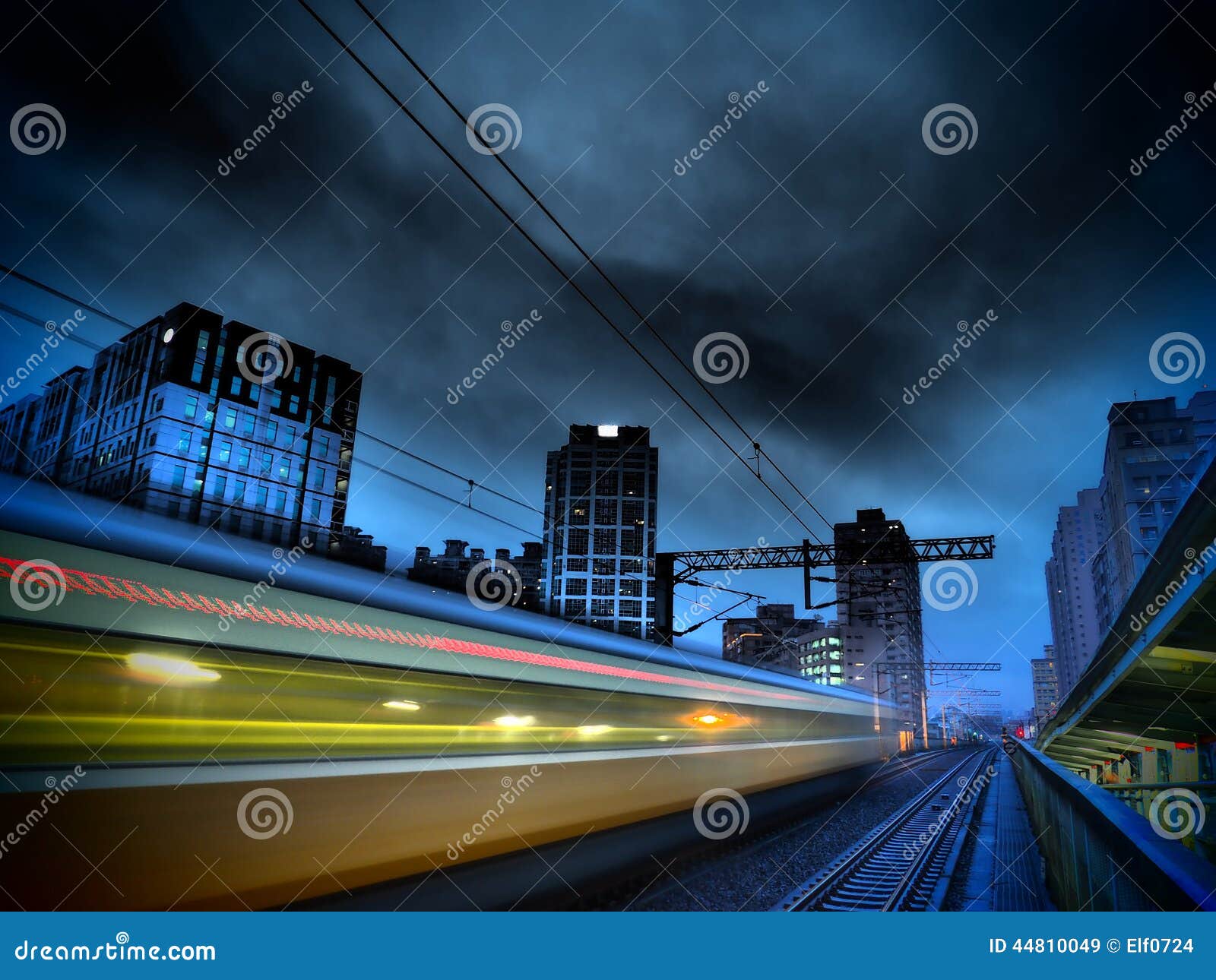 speedy train and modern city at night