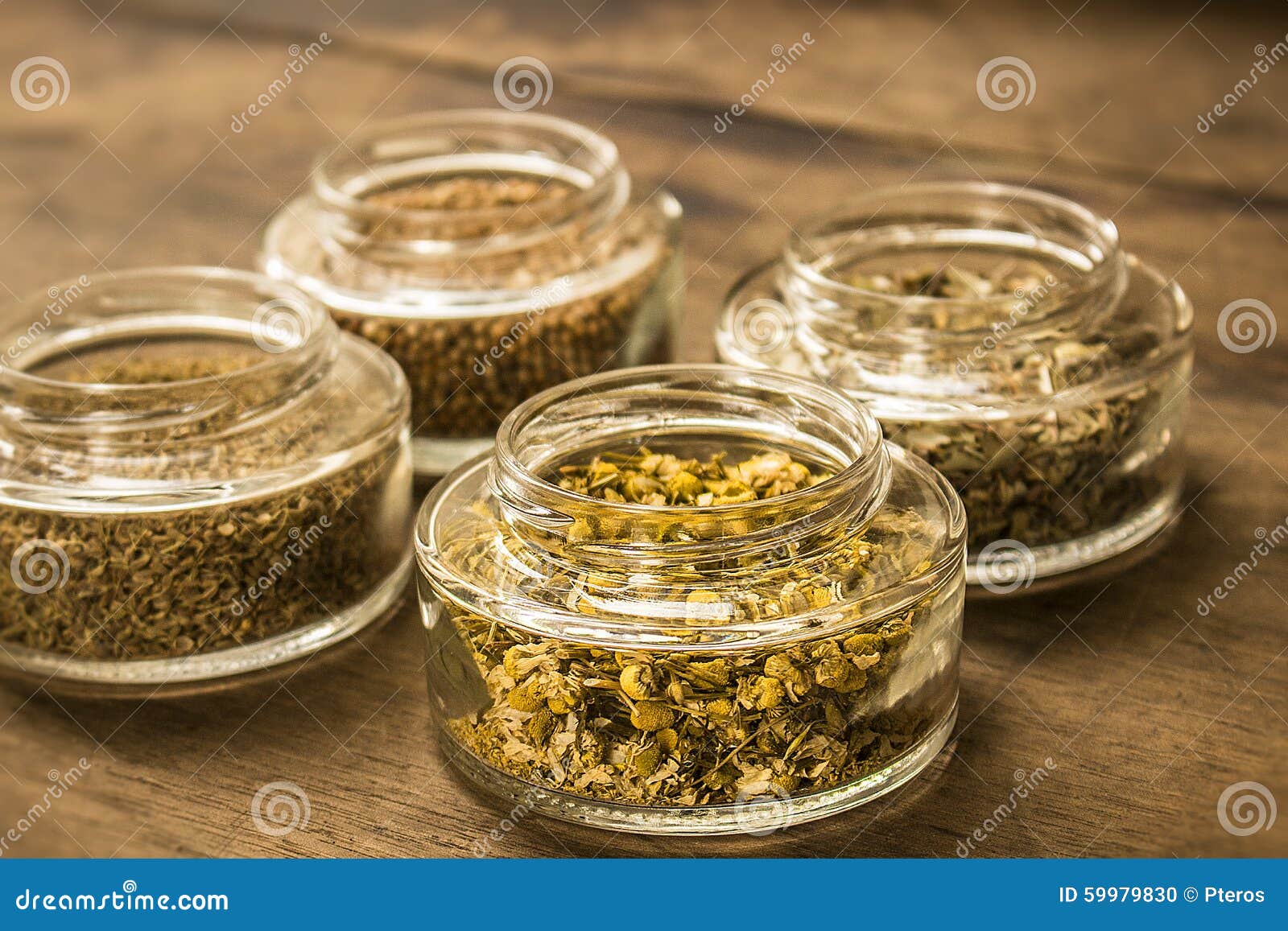 spices and herbal tea ingredients on glass jars