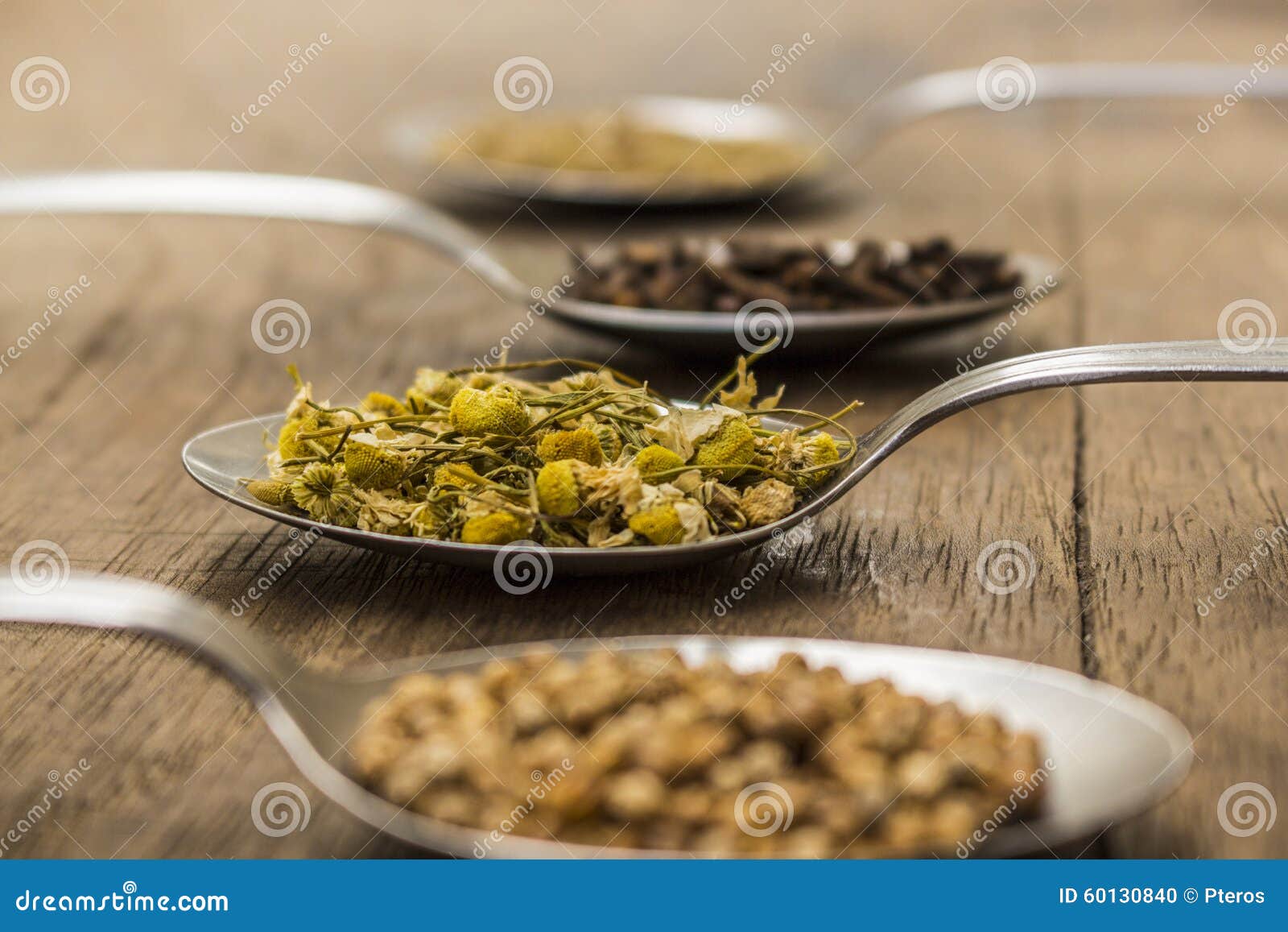 spices and herbal tea ingredients on spoons