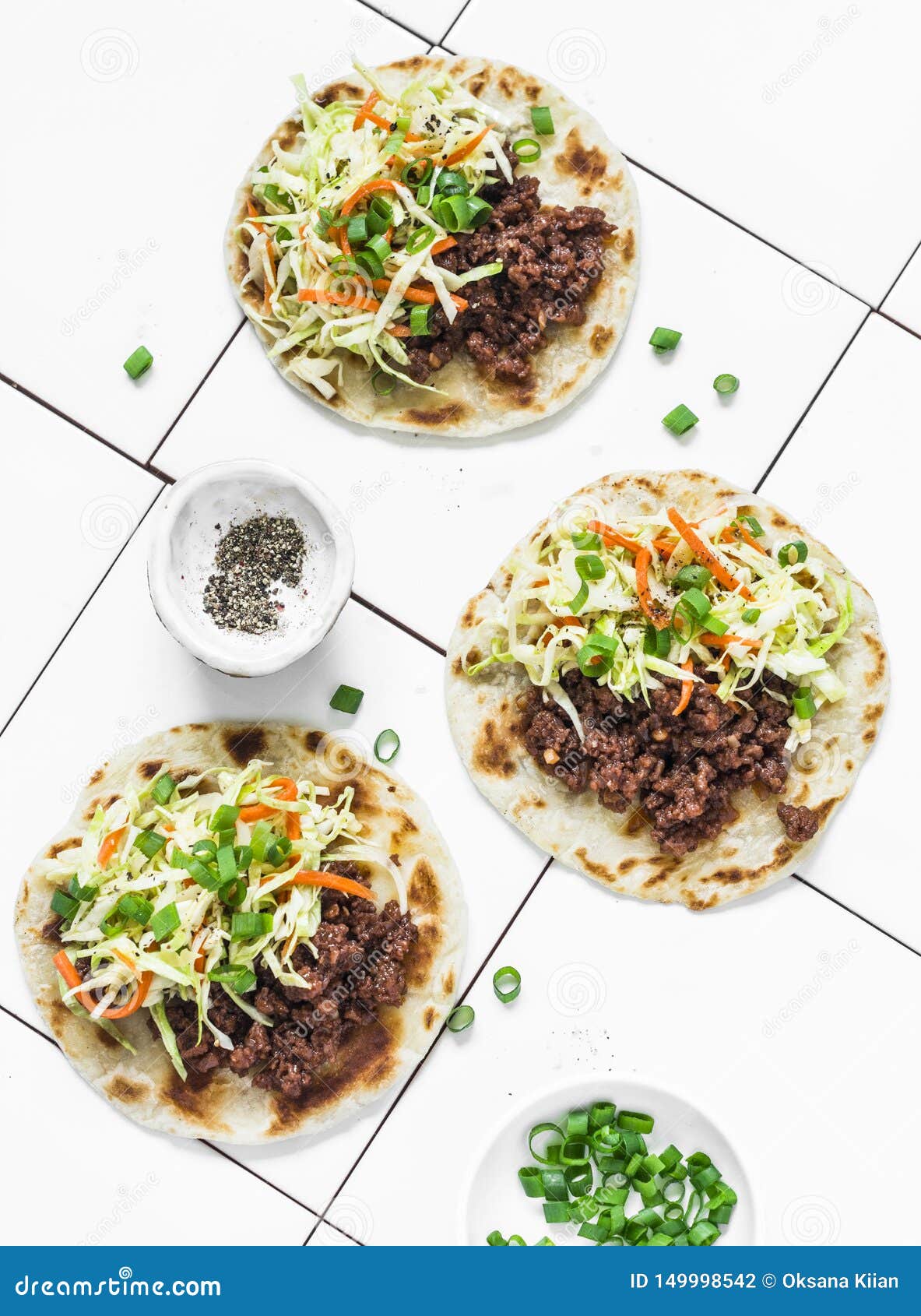 Spicy Beef and Coleslaw Tacos on Light Background, Top View Stock Photo
