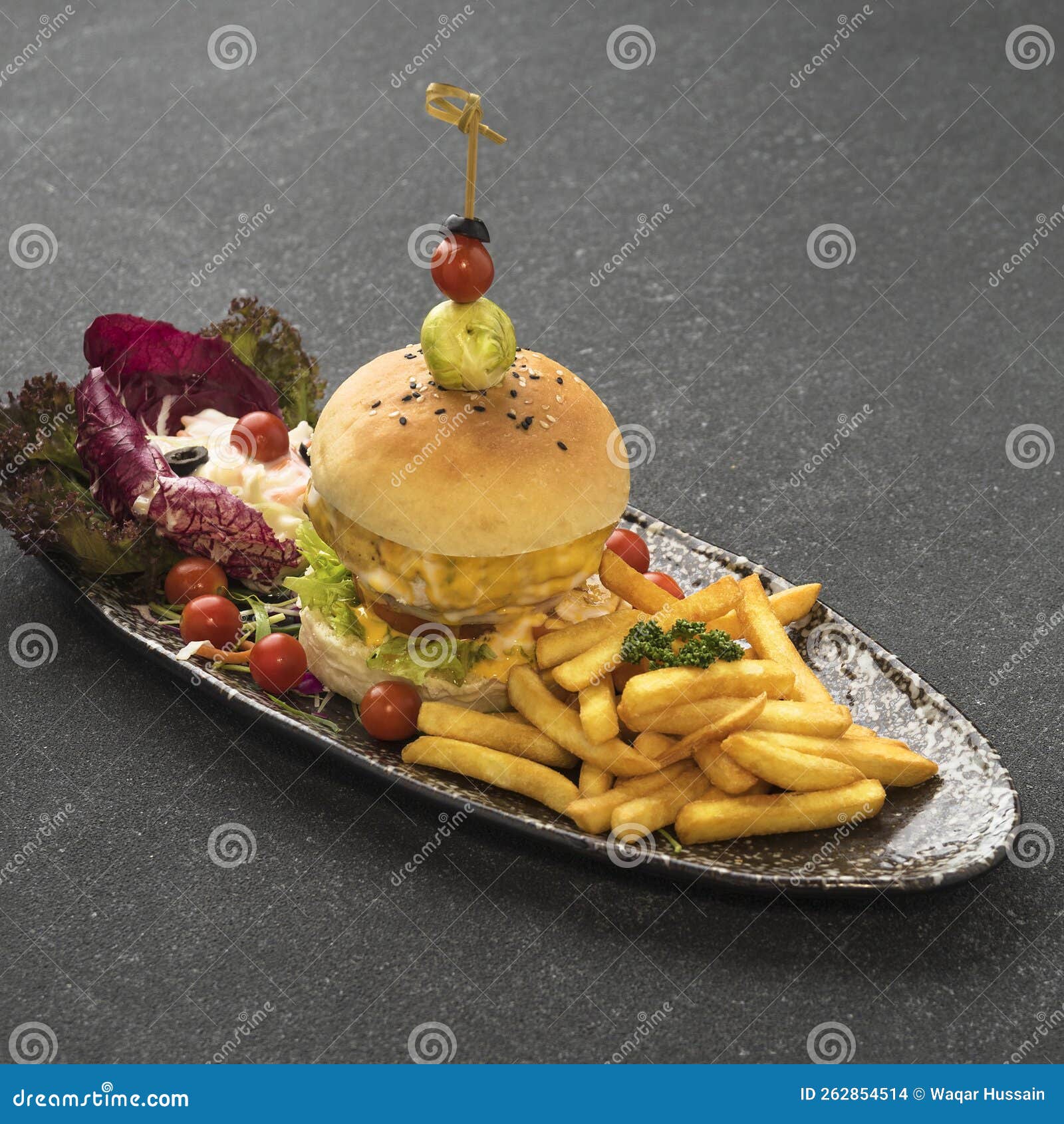spicy chicken mexicano burger with french fries served in dish  on table top view of fastfood