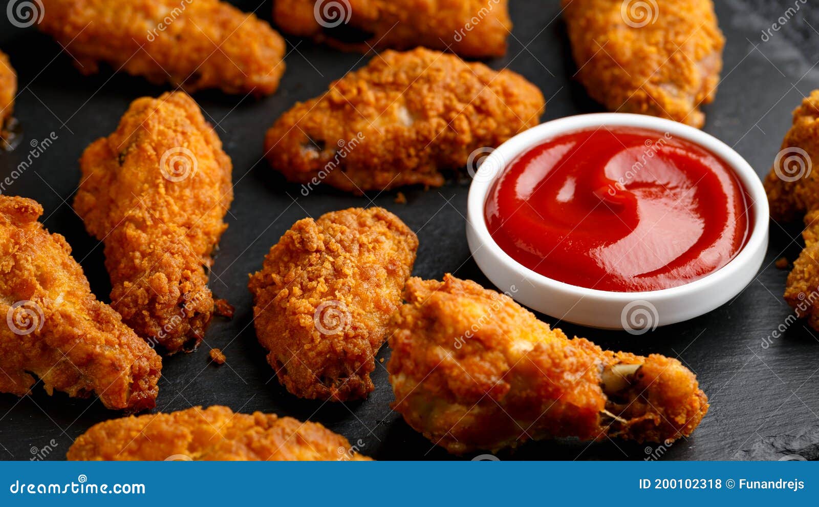 Spicy Deep Fried Chicken Wings with Ketchup on Stone Board Stock Photo