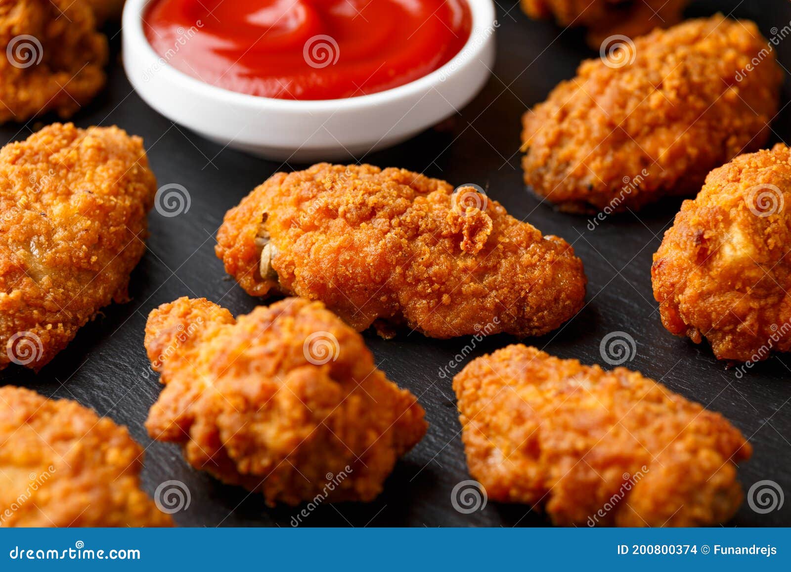 Spicy Deep Fried Chicken Wings with Ketchup on Stone Board Stock Photo