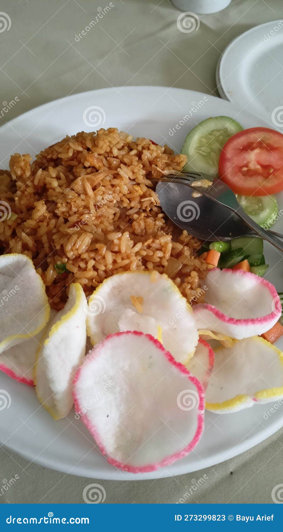 Spicy Indonesian Fried Rice with Rice Cracker and Pickle Stock Image