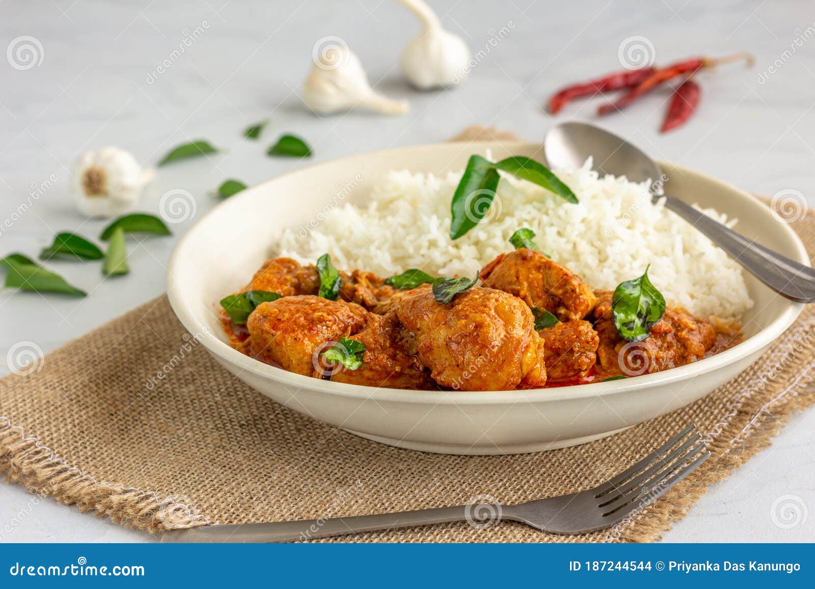Spicy South Indian Chicken Curry And Rice Garnished With Curry Leaves