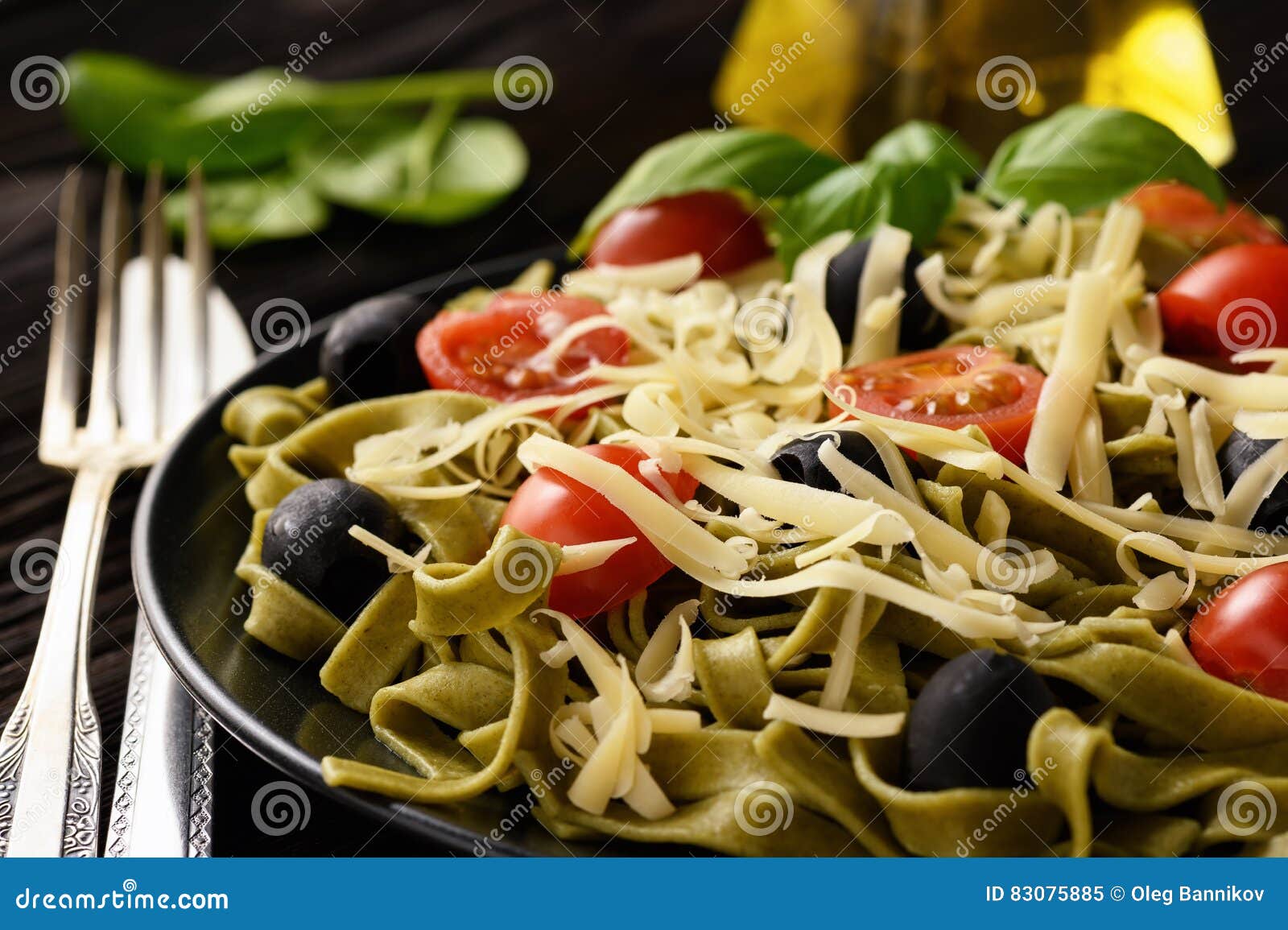 Spinach Green Pasta with Olives, Tomatoes and Cheese. Stock Image Image of gourmet