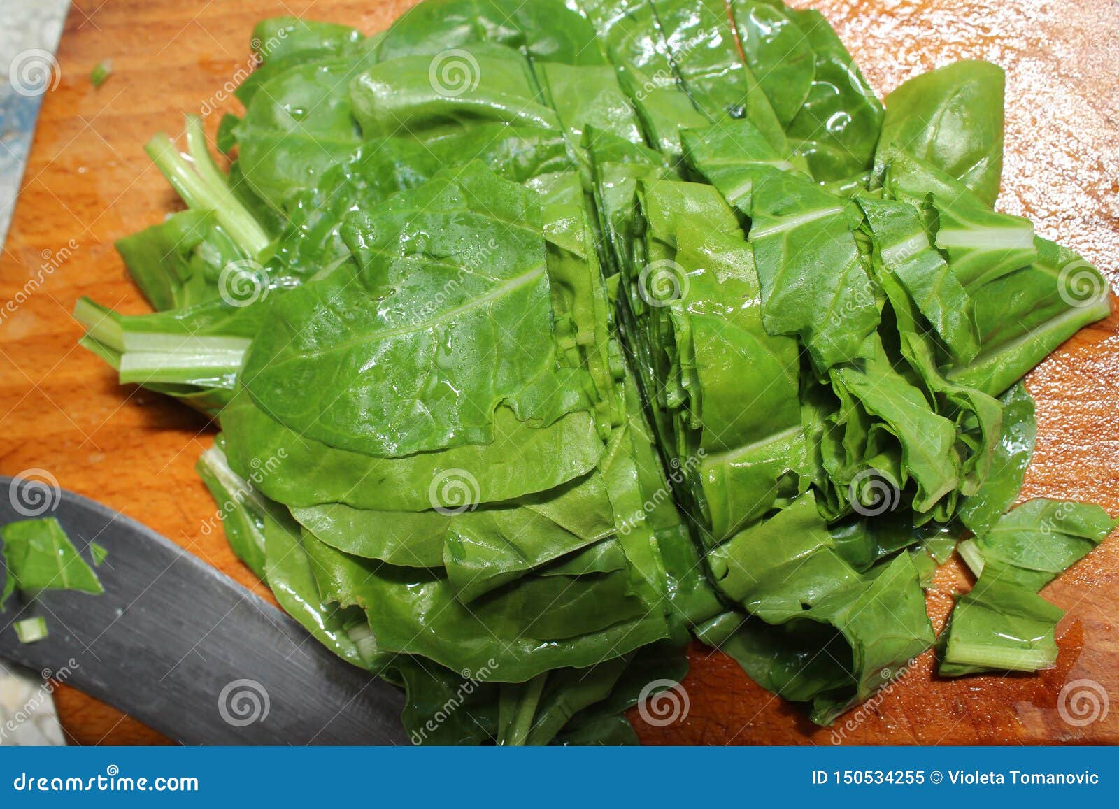 Spinach, a Leafy Green Flowering Plant. Raw Leaves and Knife on the