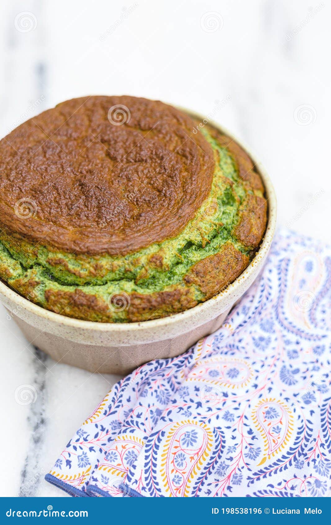 spinach souflÃÂ© in ramekin with patterned napkin